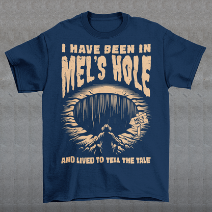 Step into the strange with this quirky and mysterious tee! Featuring a bold illustration of a curious man peering into a dark, bottomless abyss, this shirt pays homage to the legendary paranormal tale of Mel's Hole — a supposed infinite pit in the wilds of Washington State. The vintage-style artwork is topped with the eerie invitation: "VISIT MEL'S HOLE" in retro tourism font, blending humor, folklore, and a dash of the unexplained.
