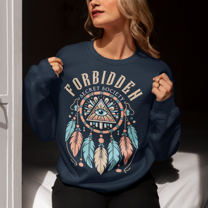 "Step into the enigmatic world of clandestine knowledge with our Illuminati Dreamcatcher sweatshirt. Featuring an intricate design that merges the mystique of the Illuminati symbol with the cultural heritage of dreamcatchers, this tee is a fusion of intrigue and symbolism. The central eye, a hallmark of Illuminati iconography, peers out from the heart of the dreamcatcher, symbolizing the pursuit of hidden truths and enlightenment.
