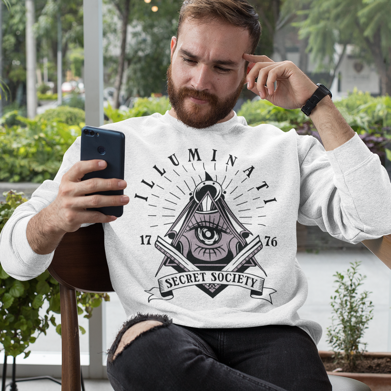 White sweatshirt with a free mason symbol and text Illuminati Secret Society.