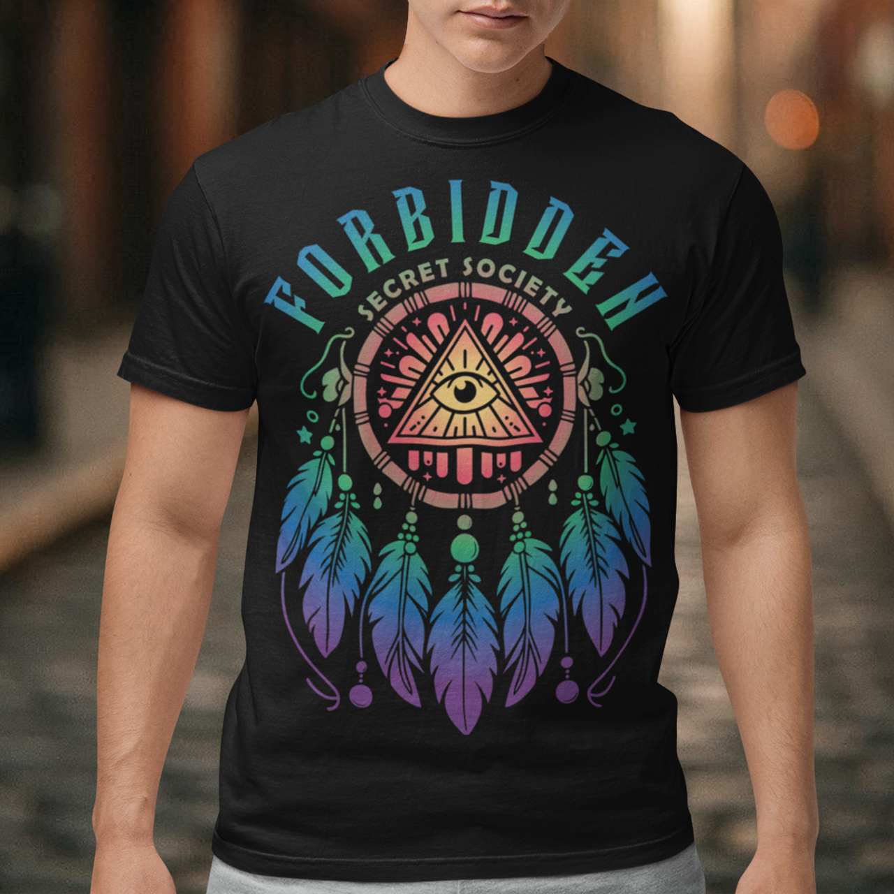 "Step into the enigmatic world of clandestine knowledge with our Illuminati Dreamcatcher T-shirt. Featuring an intricate design that merges the mystique of the Illuminati symbol with the cultural heritage of dreamcatchers, this tee is a fusion of intrigue and symbolism. The central eye, a hallmark of Illuminati iconography, peers out from the heart of the dreamcatcher, symbolizing the pursuit of hidden truths and enlightenment.