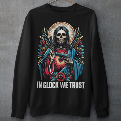 Black sweatshirt of a skeleton Jesus with two guns and text below IN GLOCK WE TRUST. 