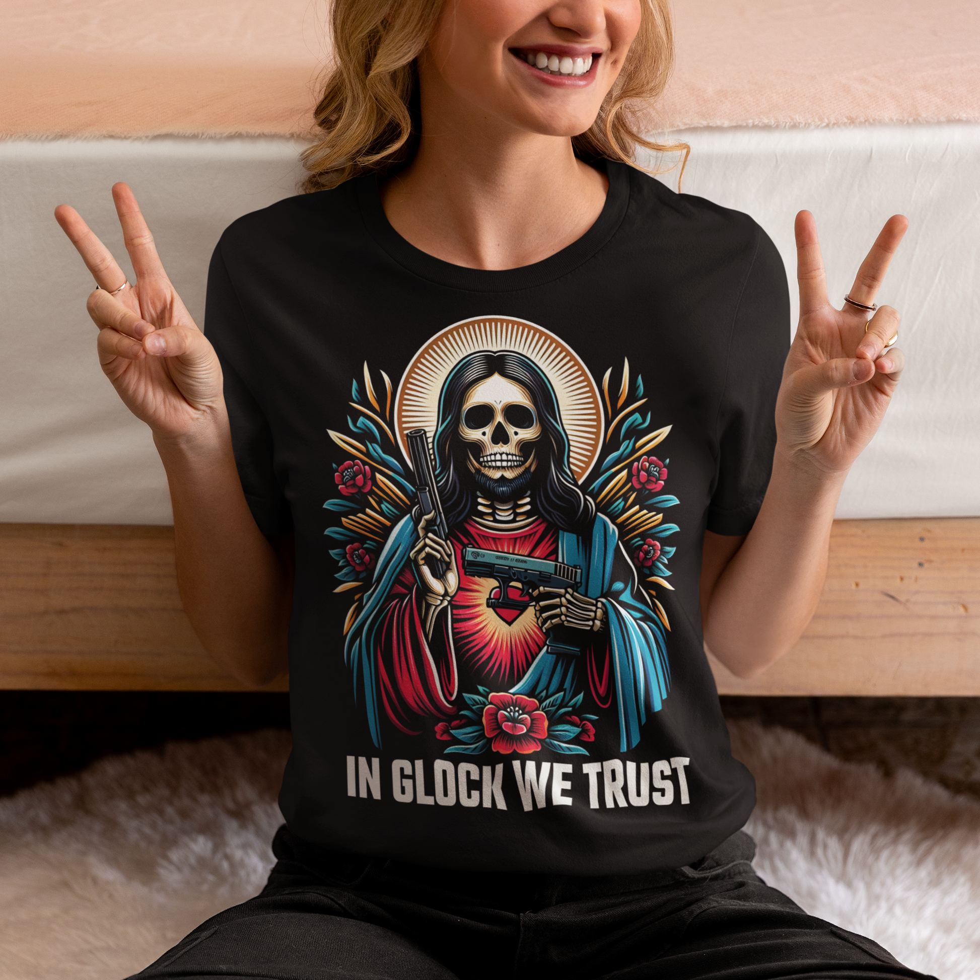 Black t-shirt of a skeleton Jesus with two guns and text below IN GLOCK WE TRUST. 