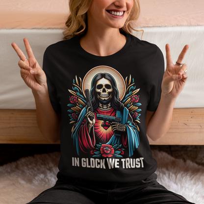 Unveil your bold style with our audacious "Skeleton Jesus - In Glock We Trust" t-shirt. This striking design features a skeletal representation of Jesus, wielding two gleaming guns, embodying a powerful juxtaposition of traditional religious iconography and modern, edgy street art. The graphic is intricately detailed, with the skeletal Jesus standing confidently, the guns adding an intense, rebellious flair.
