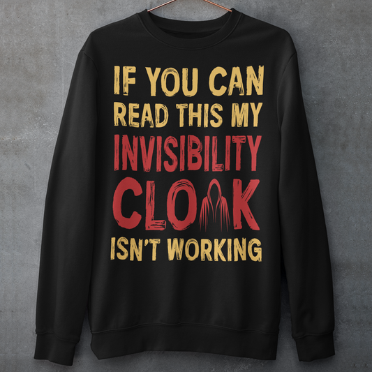 Turn heads and raise a few laughs with this clever and quirky sweatshirt! Featuring the bold text “IF YOU CAN READ THIS MY INVISIBILITY CLOAK ISN'T WORKING”, this shirt is perfect for wizards, pranksters, and introverts alike. Whether you're a fan of fantasy, sarcasm, or just enjoy flying under the radar, this shirt delivers a magical dose of humor.