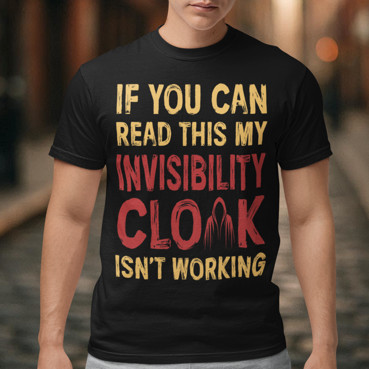 Turn heads and raise a few laughs with this clever and quirky tee! Featuring the bold text “IF YOU CAN READ THIS MY INVISIBILITY CLOAK ISN'T WORKING”, this shirt is perfect for wizards, pranksters, and introverts alike. Whether you're a fan of fantasy, sarcasm, or just enjoy flying under the radar, this shirt delivers a magical dose of humor.