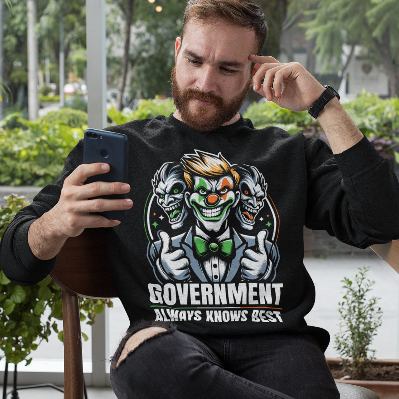 Black sweatshirt of a government clown with text GOVERNMENT ALWAYS KNOWS BEST.