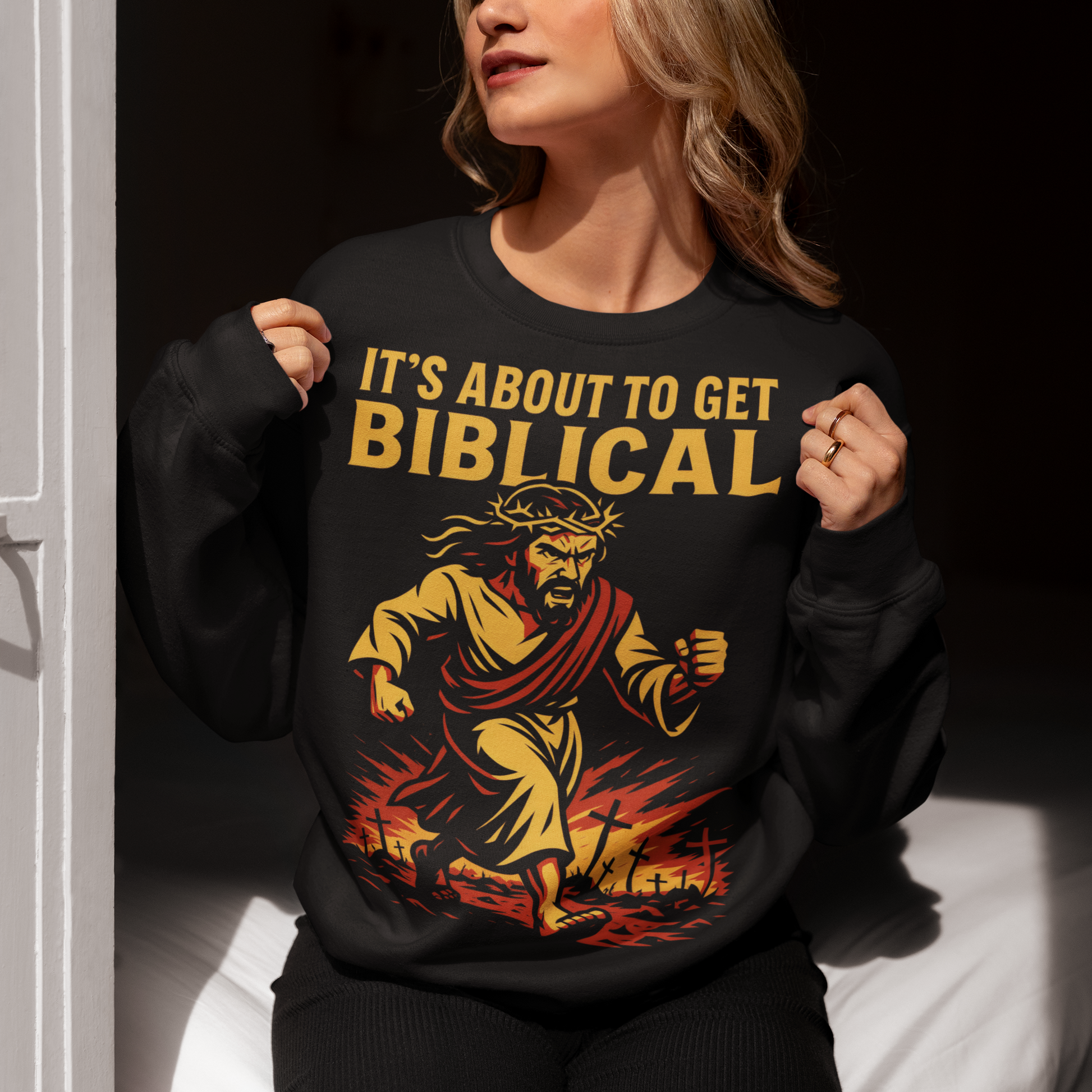 This black sweatshirt delivers bold faith-meets-humor with a striking illustration and an unmistakable statement: “It’s About To Get Biblical.” Featuring a dynamic, vintage-style depiction of Jesus charging forward through fire and fallen crosses, the artwork blends dramatic religious imagery with modern meme culture. Warm gold and red tones pop against the dark fabric, giving the design an old-school poster feel with unapologetic attitude.