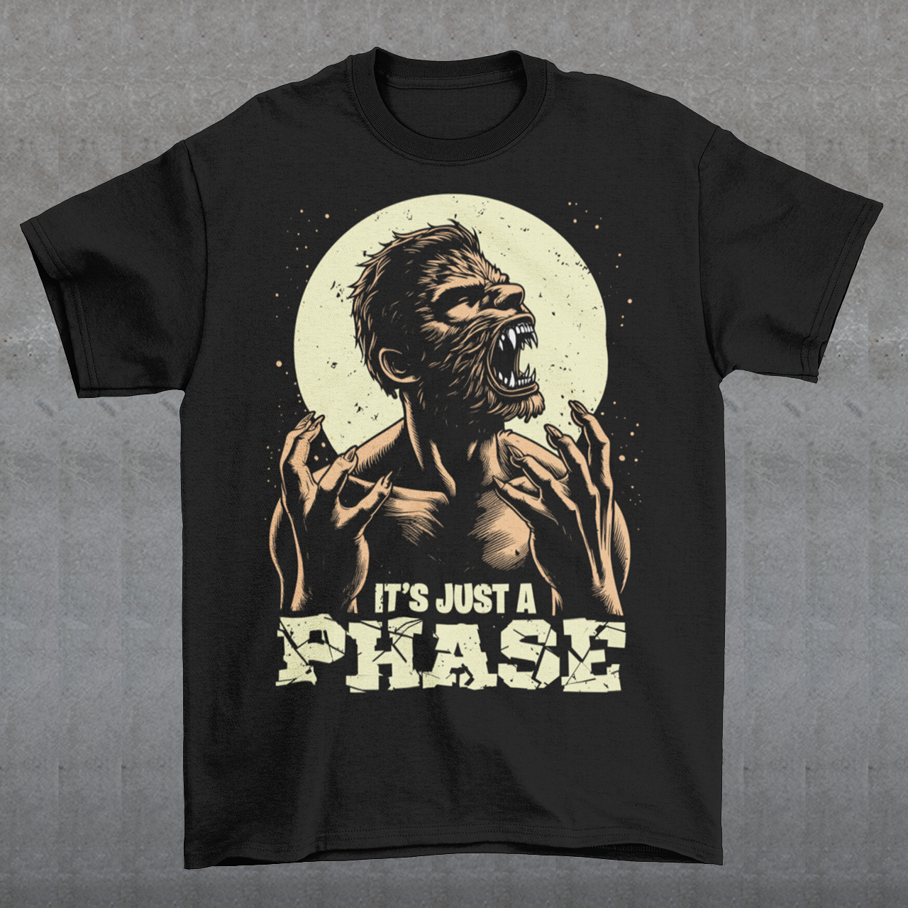 This t-shirt features a dynamic illustration of a man mid-transformation into a fearsome werewolf under the glow of a full moon. His human features contort as claws emerge, fur spreads across his body, and his eyes glow with a supernatural intensity. Below the image, the humorous and clever text reads: "IT'S JUST A PHASE," playfully alluding to both the lunar cycle and the werewolf's transformation.