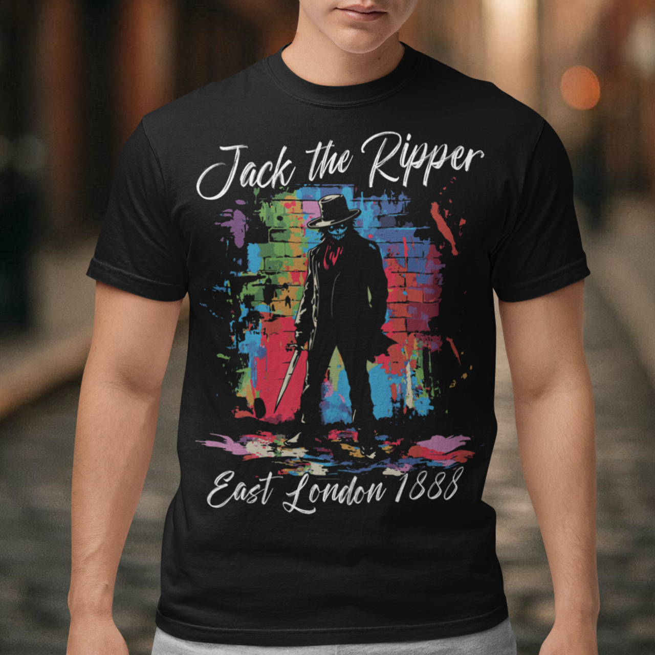 This striking T-shirt features a gritty, graffiti-inspired design of Jack the Ripper, blending urban street art with Victorian-era mystery. The graphic shows a dark, shadowy figure with subtle splatters and rough lines, capturing the chilling essence of London's most notorious figure. Graffiti text above reads "Jack the Ripper," while below, "East London 1888" adds an authentic touch, grounding the design in its historical setting.