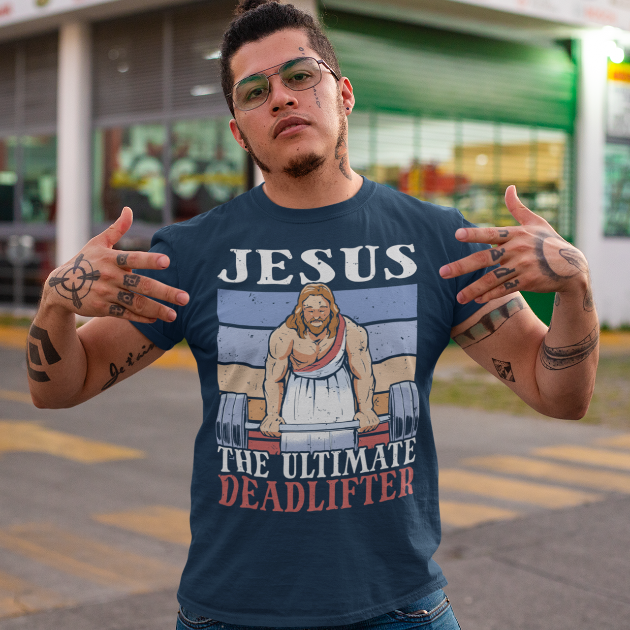 Navy t-shirt with Jesus deadlifting with text "JESUS THE ULTIMATE DEADLIFTER".