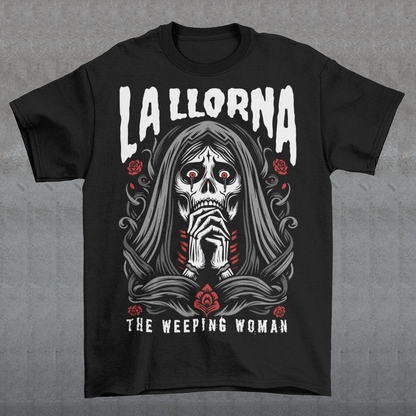 This striking La Llorona t-shirt features a haunting depiction of the legendary Weeping Woman, her ghostly figure shrouded in mist, with flowing hair and a sorrowful expression as she searches for her lost children. The design captures the eerie, chilling essence of the famous Latin American folktale, blending dark, gothic tones with an ethereal glow. Above the image, bold lettering reads "LA LLORONA", while below, the translation "THE WEEPING WOMAN" adds to the eerie mystique. Perfect for fans of folklore