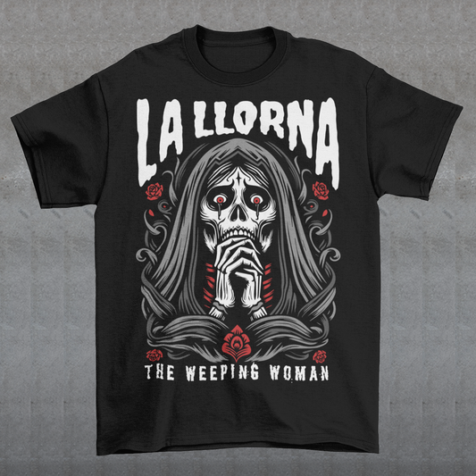 This striking La Llorona t-shirt features a haunting depiction of the legendary Weeping Woman, her ghostly figure shrouded in mist, with flowing hair and a sorrowful expression as she searches for her lost children. The design captures the eerie, chilling essence of the famous Latin American folktale, blending dark, gothic tones with an ethereal glow. Above the image, bold lettering reads "LA LLORONA", while below, the translation "THE WEEPING WOMAN" adds to the eerie mystique. Perfect for fans of folklore