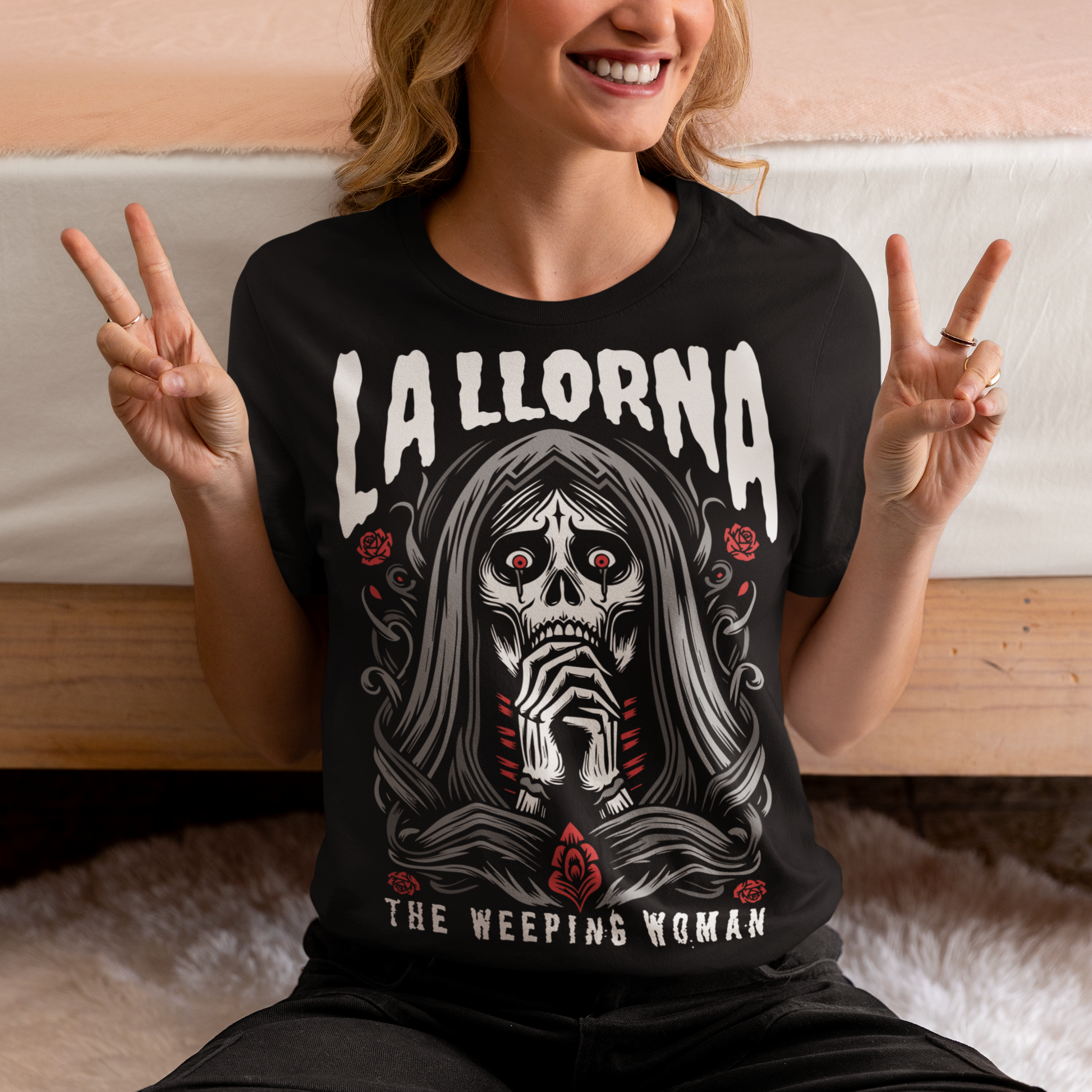 This striking La Llorona t-shirt features a haunting depiction of the legendary Weeping Woman, her ghostly figure shrouded in mist, with flowing hair and a sorrowful expression as she searches for her lost children. The design captures the eerie, chilling essence of the famous Latin American folktale, blending dark, gothic tones with an ethereal glow. Above the image, bold lettering reads "LA LLORONA", while below, the translation "THE WEEPING WOMAN" adds to the eerie mystique. Perfect for fans of folklore