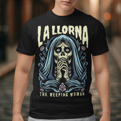 This striking La Llorona t-shirt features a haunting depiction of the legendary Weeping Woman, her ghostly figure shrouded in mist, with flowing hair and a sorrowful expression as she searches for her lost children. The design captures the eerie, chilling essence of the famous Latin American folktale, blending dark, gothic tones with an ethereal glow. Above the image, bold lettering reads "LA LLORONA", while below, the translation "THE WEEPING WOMAN" adds to the eerie mystique.