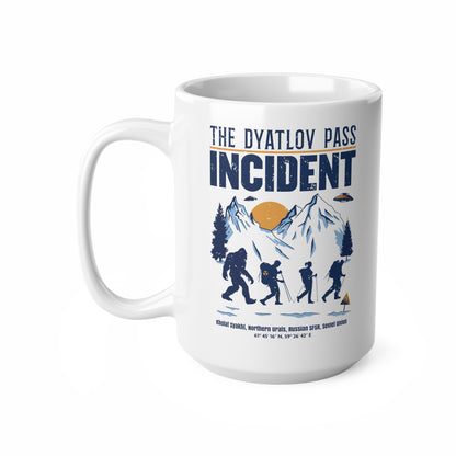 White mug of 3 hikers including Bigfoot in snowy mountains with UFOs and text THE DYATLOV PASS INCIDENT.