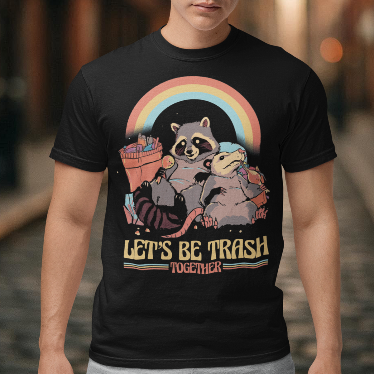 Get ready to embrace your mischievous side with this adorable raccoon and possum duo on a quest for fun! The vibrant graphic features a playful raccoon and a curious possum side by side, ready to conquer the night. Beneath this charismatic pair, bold text reads "LET'S BE TRASH TOGETHER," capturing the essence of camaraderie in their shared adventures.