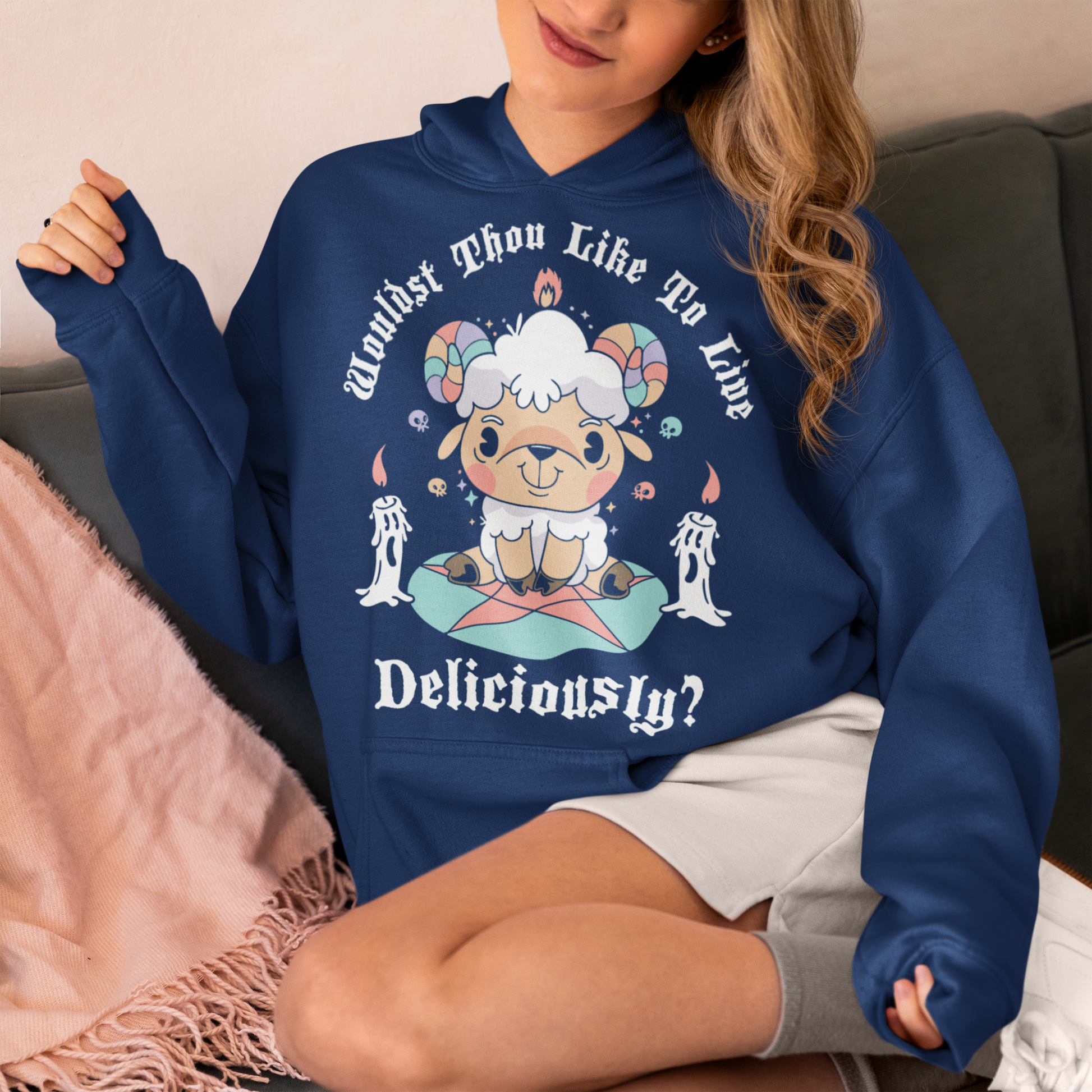 Unleash your inner rebel with this striking graphic hoodie featuring a smug, mystical goat perched atop a pentagram—summoning vibes as bold as your wardrobe. Inspired by folklore and a hint of witchy sarcasm, the chilling phrase "WOULDST THOU LIKE TO LIVE DELICIOUSLY?" is scrawled across the design in eerie, arcane lettering. Perfect for fans of the occult, dark humor, and aesthetic rebellion.
