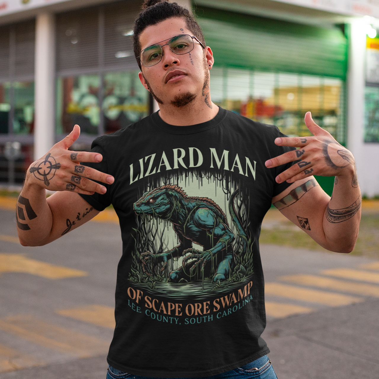 Black t-shirt of a Lizard man in a swamp with text "LIZARD MAN OF SCAPE ORE SWAMP".