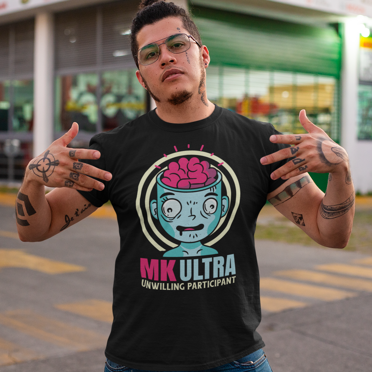 Black t-shirt of a person with brain showing with text below "MK ULTRA UNWILLING PARTICIPANT".