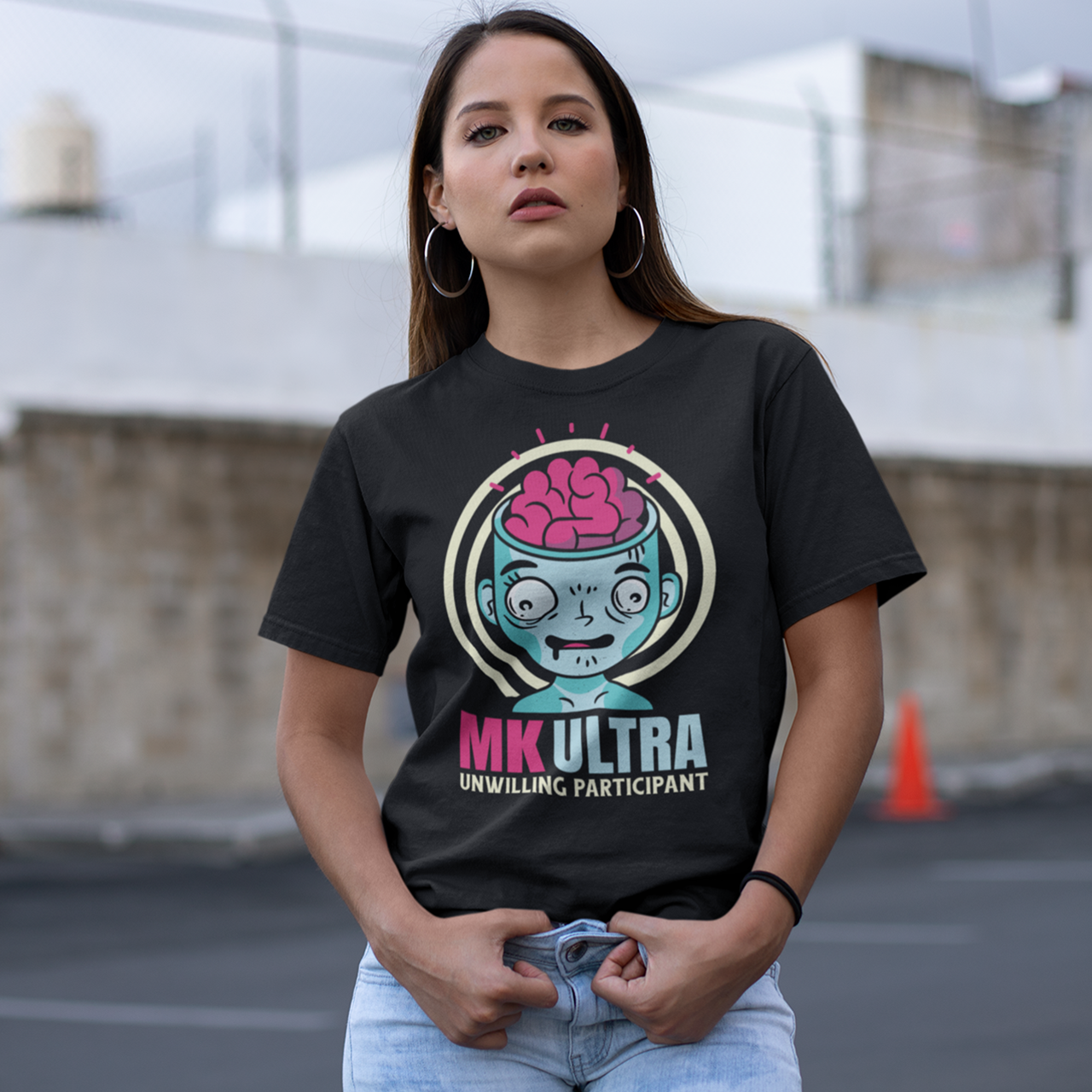 Black t-shirt of a person with brain showing with text below "MK ULTRA UNWILLING PARTICIPANT".