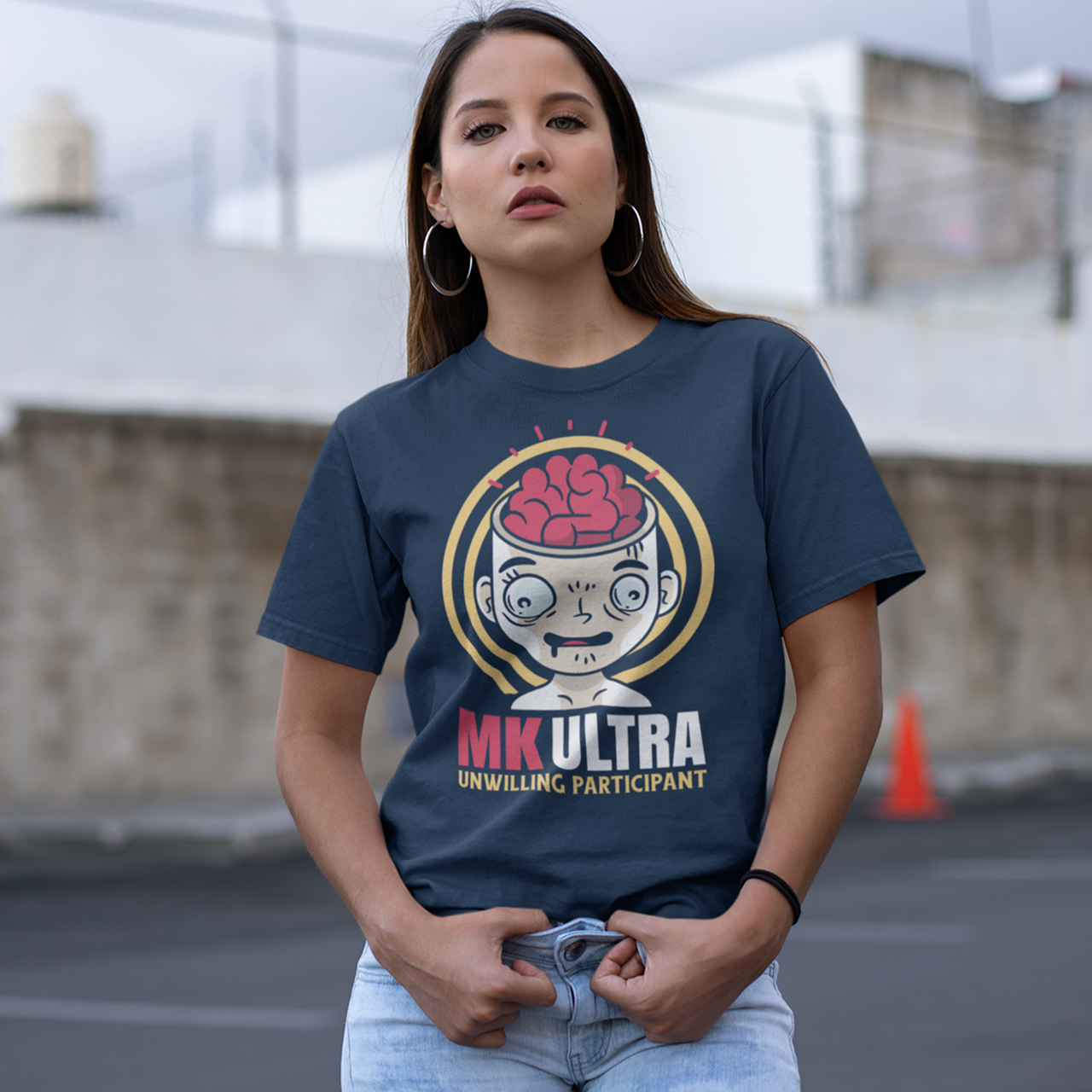 Navy t-shirt of a person with brain showing with text below "MK ULTRA UNWILLING PARTICIPANT".