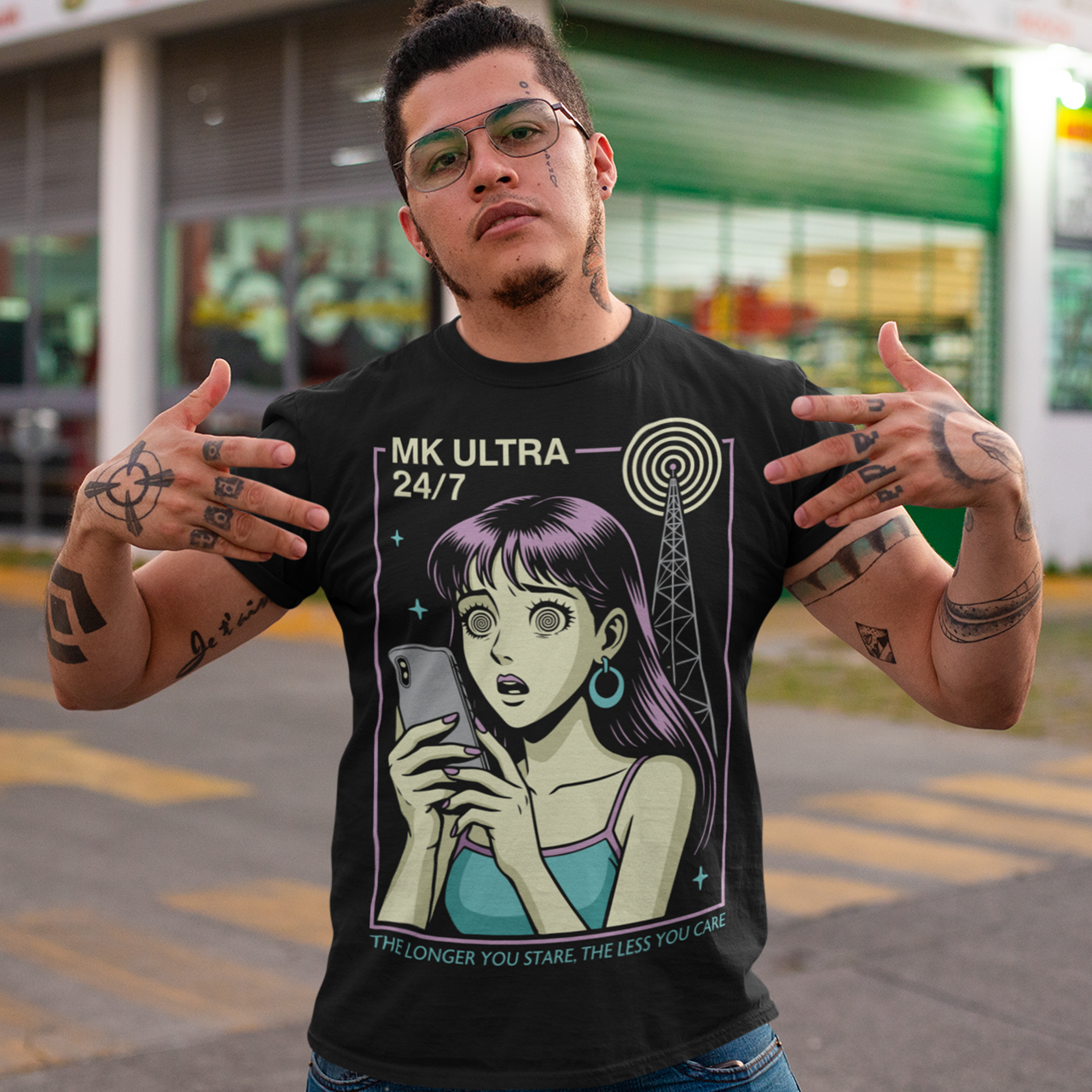 MK Ultra T-Shirt - Conspiracy Theory Shirt - Mind Control Tee - Funny Anime Gift. Step into a hypnotic, retro-futurist vibe with this MK Ultra–inspired t-shirt, where vintage anime style meets eerie mind-control lore. The design features a wide-eyed character locked into her phone, spiral eyes hinting at digital trance, while a looming signal tower pulses overhead like a silent puppeteer. It’s equal parts nostalgic, unsettling, and irresistibly cool.