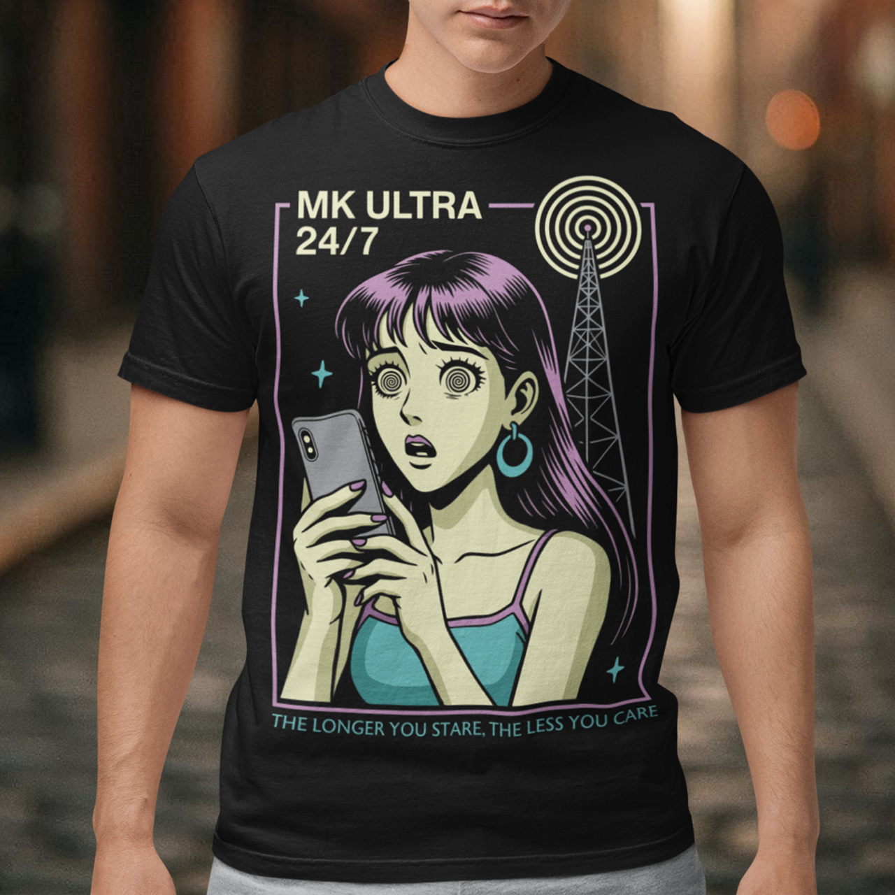 MK Ultra T-Shirt - Conspiracy Theory Shirt - Mind Control Tee - Funny Anime Gift. Step into a hypnotic, retro-futurist vibe with this MK Ultra–inspired t-shirt, where vintage anime style meets eerie mind-control lore. The design features a wide-eyed character locked into her phone, spiral eyes hinting at digital trance, while a looming signal tower pulses overhead like a silent puppeteer. It’s equal parts nostalgic, unsettling, and irresistibly cool.