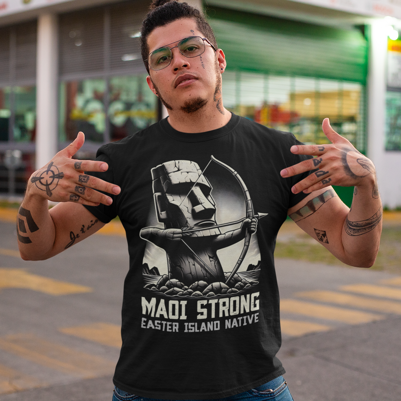 Black t-shirt of a Maoi statue with a bow and arrow on Easter Island with text underneath "MAOI STRONG EASTER ISLAND NATIVE."