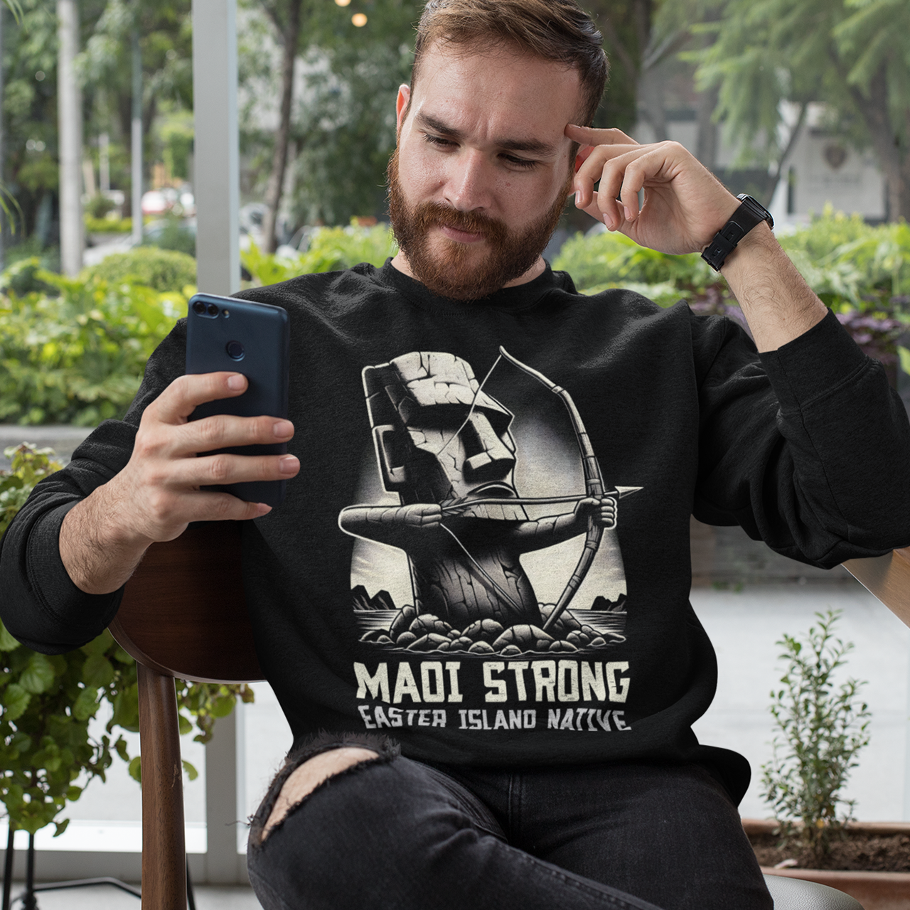 Black sweatshirt of a Maoi statue with a bow and arrow on Easter Island with text underneath "MAOI STRONG EASTER ISLAND NATIVE."