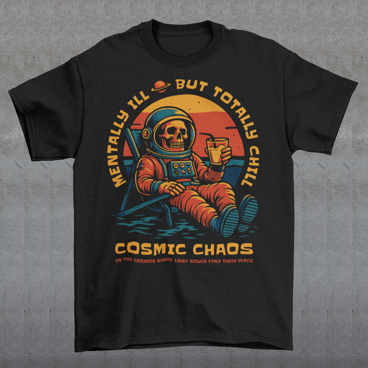 This black graphic tee features a laid-back skeleton astronaut floating in cosmic calm, drink in hand, as the universe quietly burns behind him. Bold retro colors and sunset tones frame the scene, while the phrase “Mentally Ill But Totally Chill” wraps the design with dark humor and self-aware wit. Anchored by the tagline Cosmic Chaos, it feels like a space-age postcard from the edge of existence.