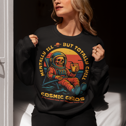 This black graphic sweatshirt features a laid-back skeleton astronaut floating in cosmic calm, drink in hand, as the universe quietly burns behind him. Bold retro colors and sunset tones frame the scene, while the phrase “Mentally Ill But Totally Chill” wraps the design with dark humor and self-aware wit. Anchored by the tagline Cosmic Chaos, it feels like a space-age postcard from the edge of existence.