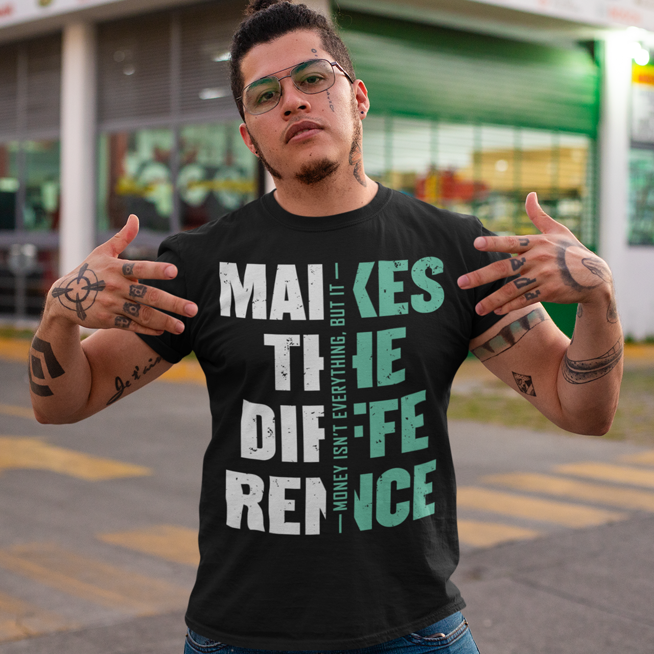 Make a bold statement with this “Money Isn’t Everything, But It Makes the Difference” t-shirt — perfect for hustlers, dreamers, and go-getters who know the value of hard work. Featuring a striking distressed typography design in bold white and teal on a sleek black background, this shirt blends motivation with modern streetwear style. Whether you’re building your empire or just love a powerful quote tee, this shirt keeps your mindset and style on point.