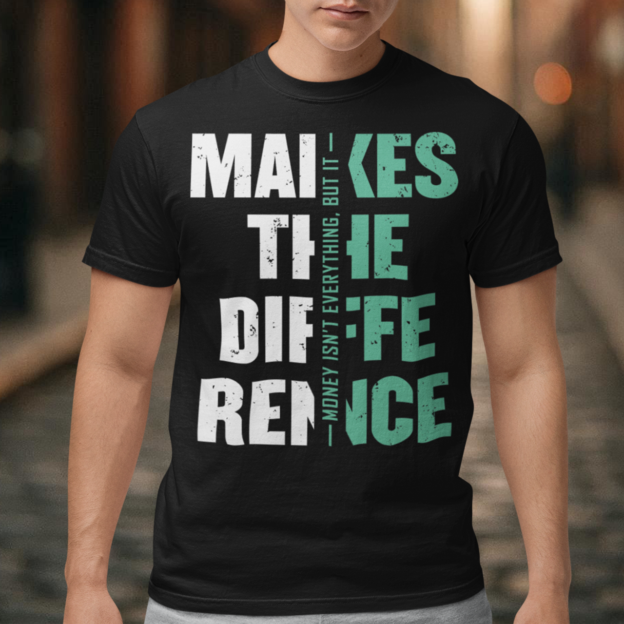 Make a bold statement with this “Money Isn’t Everything, But It Makes the Difference” t-shirt — perfect for hustlers, dreamers, and go-getters who know the value of hard work. Featuring a striking distressed typography design in bold white and teal on a sleek black background, this shirt blends motivation with modern streetwear style. Whether you’re building your empire or just love a powerful quote tee, this shirt keeps your mindset and style on point.