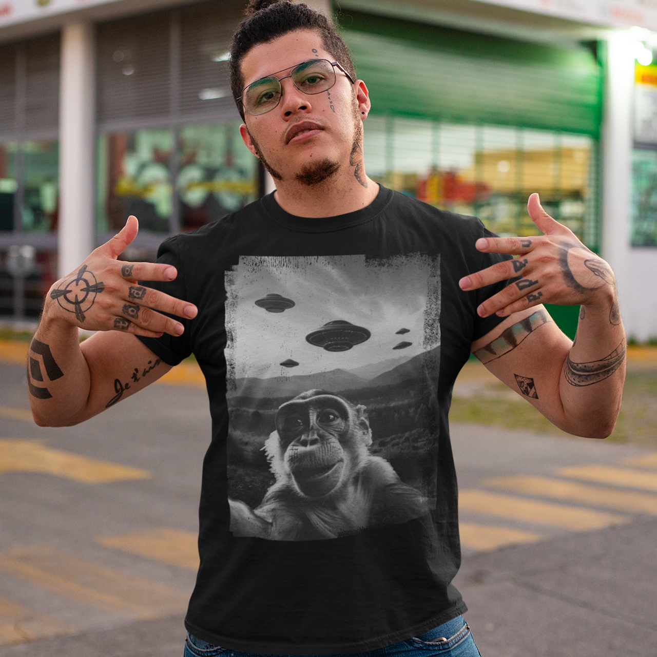 Black t-shirt of a monkey taking a selfie with UFOs in the background.