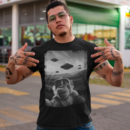 Introducing our whimsical and out-of-this-world "Cosmic Monkey Selfie" t-shirt! Prepare to embark on a journey through the cosmos with our cheeky primate friend as your guide. Picture this: a mischievous monkey capturing the ultimate selfie moment with a backdrop that's truly out of this world. Centered on the front of the shirt, our lovable monkey strikes a pose, grinning from ear to ear as it snaps a selfie with a group of UFOs hovering in the distant sky.