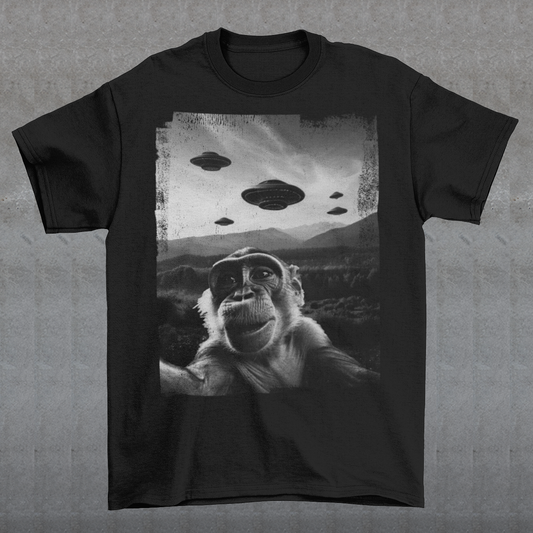 Introducing our whimsical and out-of-this-world "Cosmic Monkey Selfie" t-shirt! Prepare to embark on a journey through the cosmos with our cheeky primate friend as your guide. Picture this: a mischievous monkey capturing the ultimate selfie moment with a backdrop that's truly out of this world. Centered on the front of the shirt, our lovable monkey strikes a pose, grinning from ear to ear as it snaps a selfie with a group of UFOs hovering in the distant sky.