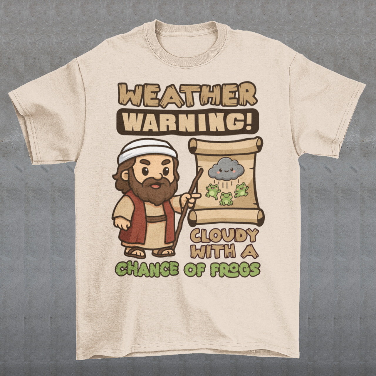 Beige t-shirt featuring a cute cartoon Moses pointing at a weather scroll that shows a smiling rain cloud and falling frogs. The text reads “Weather Warning! Cloudy With a Chance of Frogs.” The design uses playful retro colors with funny biblical humor inspired by the plague of frogs story