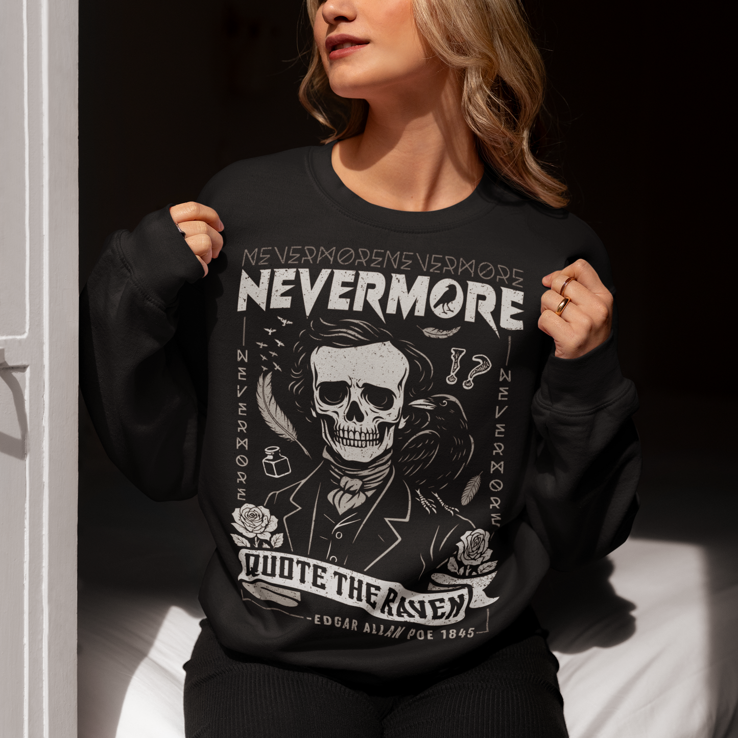 Quote The Raven Nevermore Sweatshirt - Edgar Allen Poe Shirt. Step into the haunting world of classic literature with this striking “Nevermore” t-shirt, inspired by the timeless work of Edgar Allan Poe. Featuring a skeletal portrait of the iconic poet alongside a watchful raven, this design captures the eerie essence of The Raven with bold gothic flair. Surrounded by dark symbolism like feathers, ink, and cryptic details, the artwork evokes a sense of mystery, melancholy, and poetic obsession.