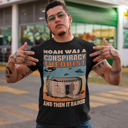 Black t-shirt of Noah's Ark with bigfoot and UFOs above with aliens with a retro background with text  "NOAH WAS A CONSPIRACY THEORIST AND THEN IT RAINED".