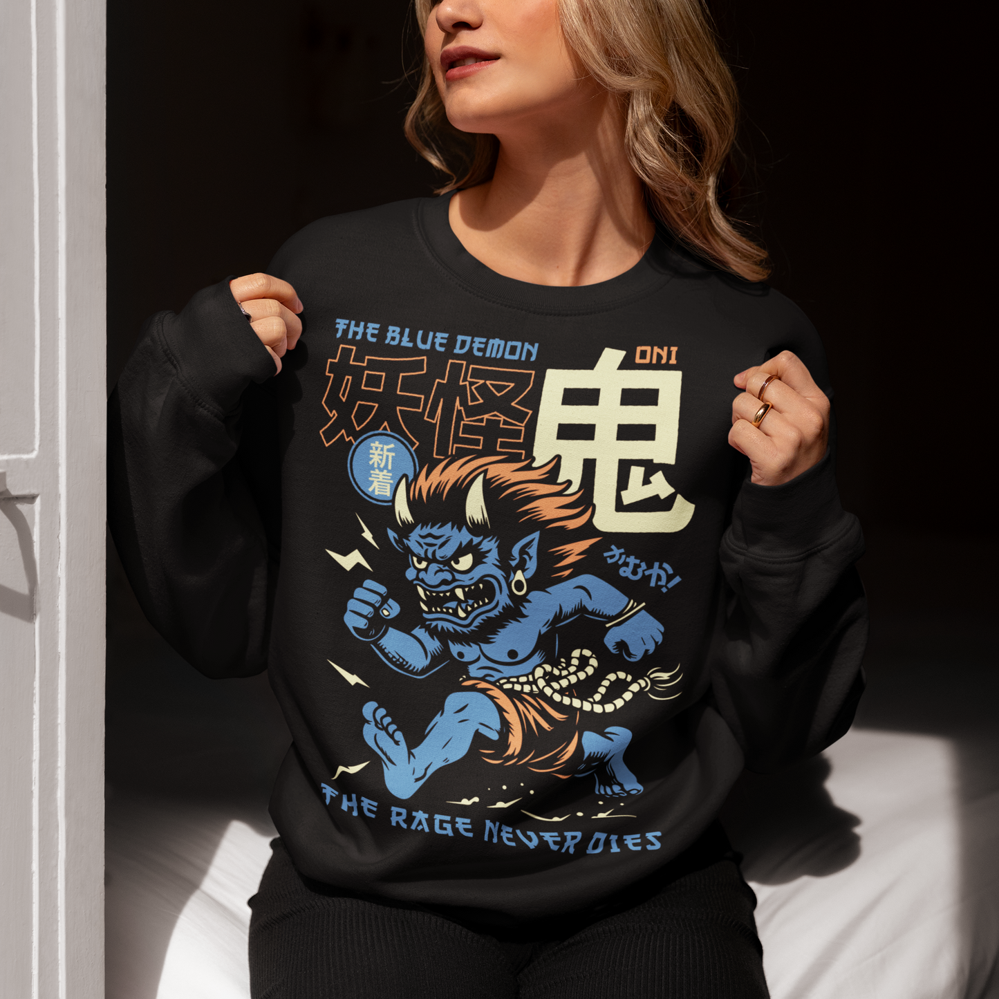 Bold, fierce, and unstoppable — this dynamic sweatshirt features a powerful Japanese Oni mid-sprint, eyes blazing and muscles tense with fury. Above the image, bold text declares "THE PINK DEMON", while below, a chilling reminder reads: "THE RAGE NEVER DIES". This shirt captures the raw energy and mythic wrath of the Oni spirit — perfect for those who embrace intensity and never back down.