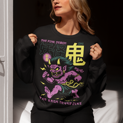 Bold, fierce, and unstoppable — this dynamic sweatshirt features a powerful Japanese Oni mid-sprint, eyes blazing and muscles tense with fury. Above the image, bold text declares "THE PINK DEMON", while below, a chilling reminder reads: "THE RAGE NEVER DIES". This shirt captures the raw energy and mythic wrath of the Oni spirit — perfect for those who embrace intensity and never back down.