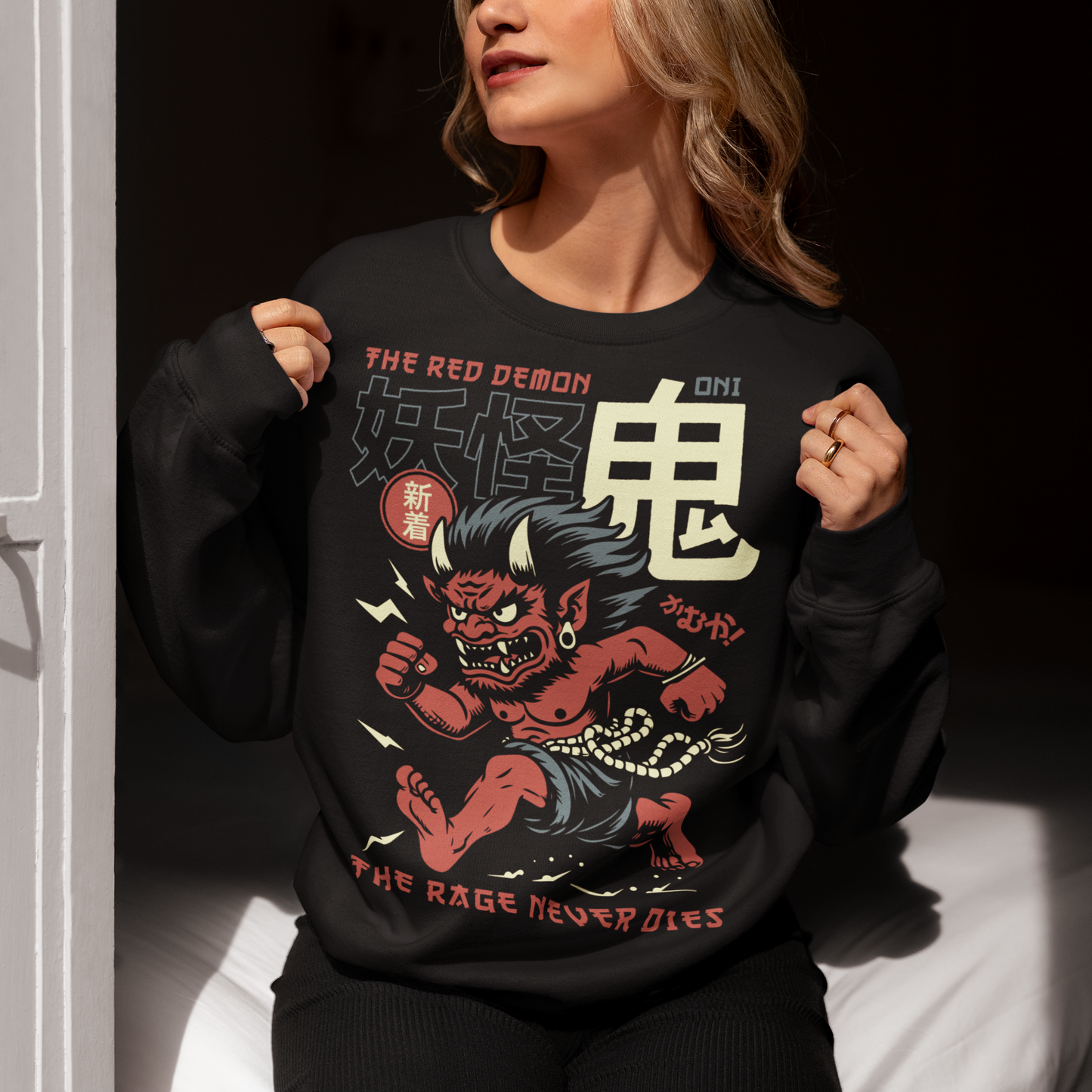 Bold, fierce, and unstoppable — this dynamic sweatshirt features a powerful Japanese Oni mid-sprint, eyes blazing and muscles tense with fury. Above the image, bold text declares "THE PINK DEMON", while below, a chilling reminder reads: "THE RAGE NEVER DIES". This shirt captures the raw energy and mythic wrath of the Oni spirit — perfect for those who embrace intensity and never back down.