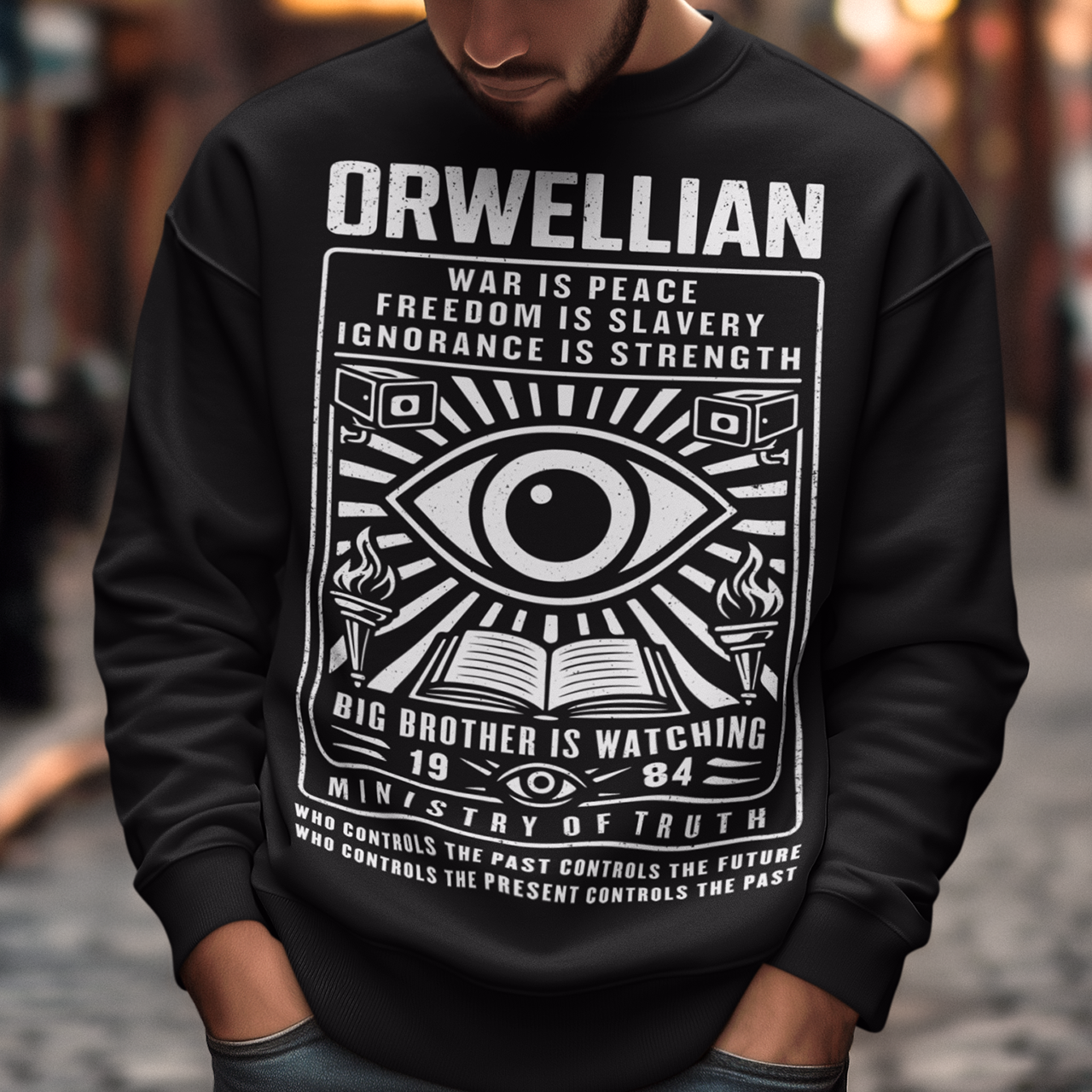 This black Sweatshirt channels the unsettling spirit of George Orwell’s 1984 with bold, high-contrast artwork and iconic slogans that refuse to whisper. The all-seeing eye dominates the design, flanked by surveillance cameras, burning torches, and an open book, a visual chorus of control, truth, and resistance. Phrases like “War Is Peace,” “Freedom Is Slavery,” and “Ignorance Is Strength” sit beneath the unmistakable warning: Big Brother Is Watching.