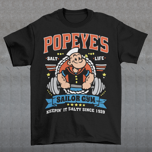 Hit the gym like a legend with the Popeye’s Sailor Gym tee! Inspired by everyone’s favorite spinach-powered sailor, this shirt is perfect for lifting, lounging, or showing off your old-school strength. Featuring a vintage-style graphic of Popeye pumping iron with the slogan "Keepin' It Salty Since 1929", this tee brings serious muscle and serious nostalgia.
