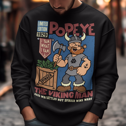 Channel old-school cartoon strength with this bold Popeye Viking graphic sweatshirt, where classic sailor swagger sails north into Viking territory. This playful design features a bearded Viking version of the legendary spinach-powered sailor, proudly gripping an axe beside a crate of spinach. With retro comic styling, vintage textures, and the iconic phrase “I Yam What I Yam,” the artwork celebrates the timeless humor and toughness that made the character famous.