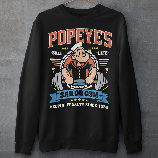 Hit the gym like a legend with the Popeye’s Sailor Gym Sweatshirt! Inspired by everyone’s favorite spinach-powered sailor, this shirt is perfect for lifting, lounging, or showing off your old-school strength. Featuring a vintage-style graphic of Popeye pumping iron with the slogan "Keepin' It Salty Since 1929", this tee brings serious muscle and serious nostalgia.
