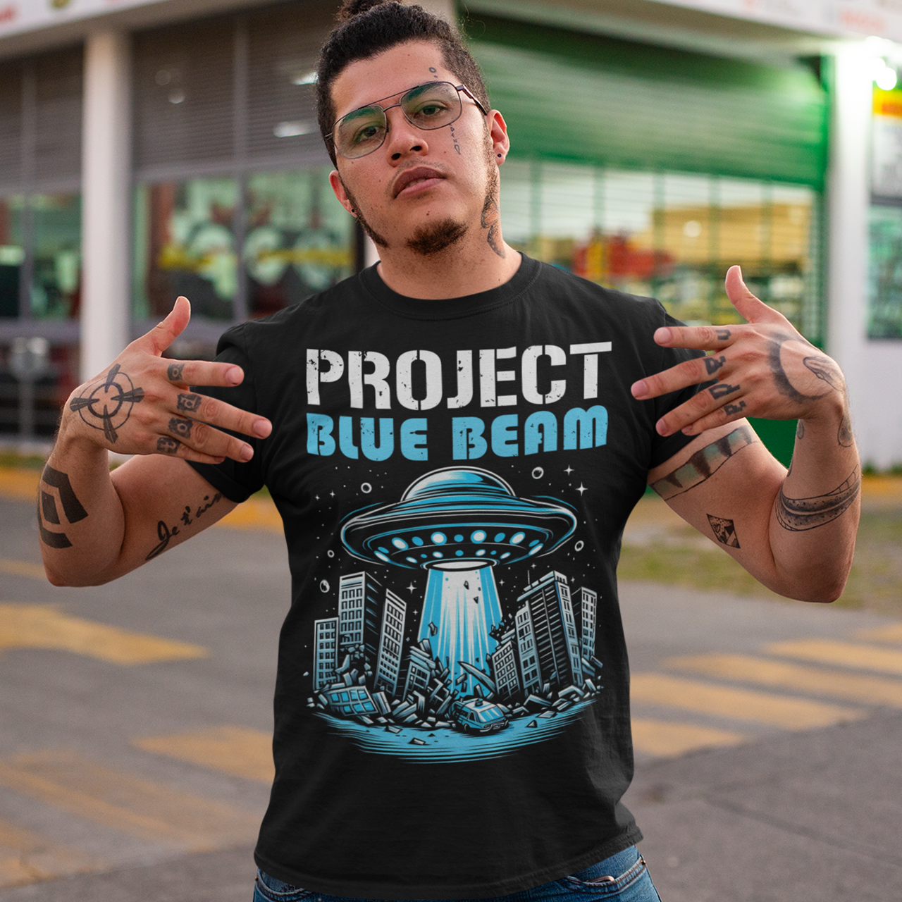 Black t-shirt of a UFO destroying a city and text "PROJECT BLUE BEAM."