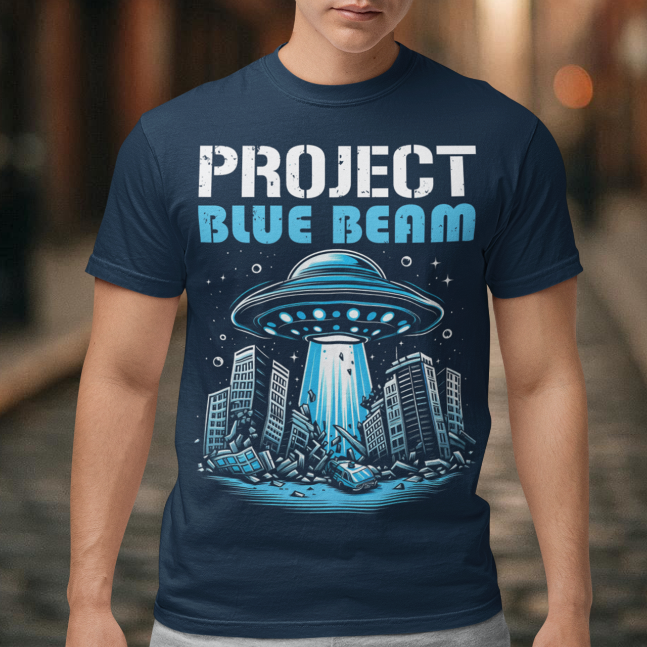 This bold and striking t-shirt features a dramatic scene of a UFO hovering menacingly above a futuristic city, casting a glowing beam of light that tears through skyscrapers, causing chaos and destruction below. The detailed artwork captures the intensity of the moment, with crumbling buildings giving the design an apocalyptic feel. Above the imagery, the text "PROJECT BLUE BEAM" is emblazoned in bold, futuristic typography, adding a mysterious and conspiracy-driven edge to the design.