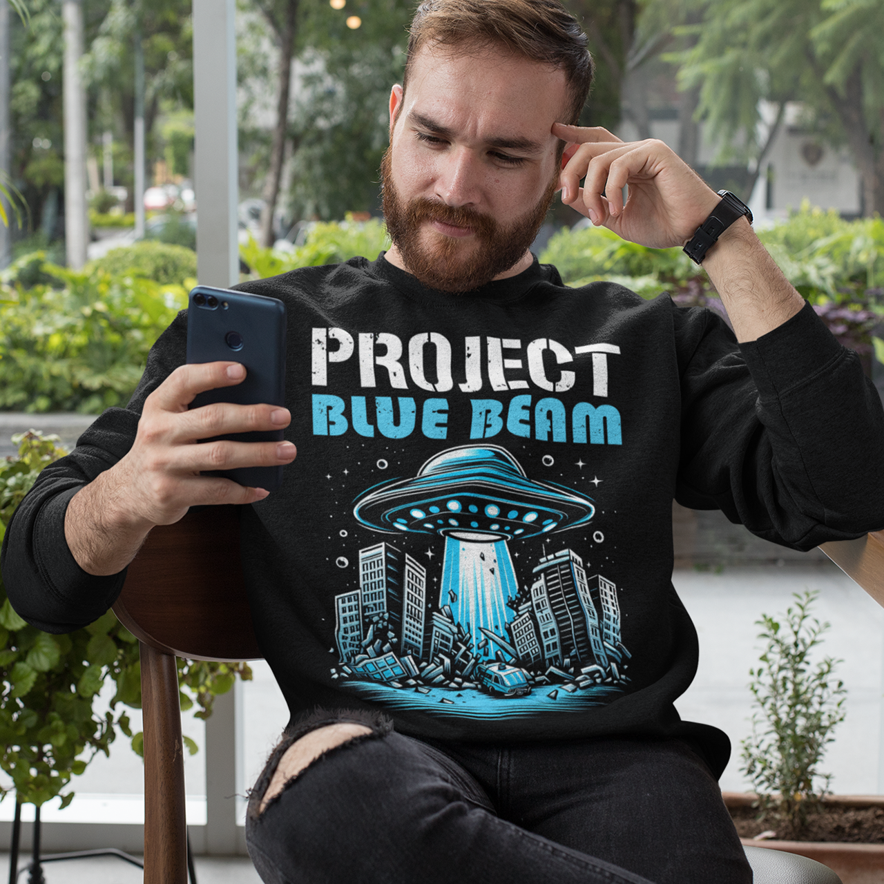 Black sweatshirt of a UFO destroying a city and text "PROJECT BLUE BEAM."