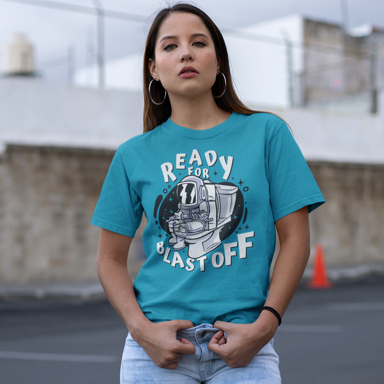 Aqua t-shirt of astronaut sitting on toilet with text "READY FOR BLAST OFF".